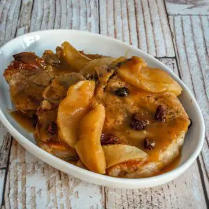 braised pork chops with apples, raisins, and molasses in a serving dish