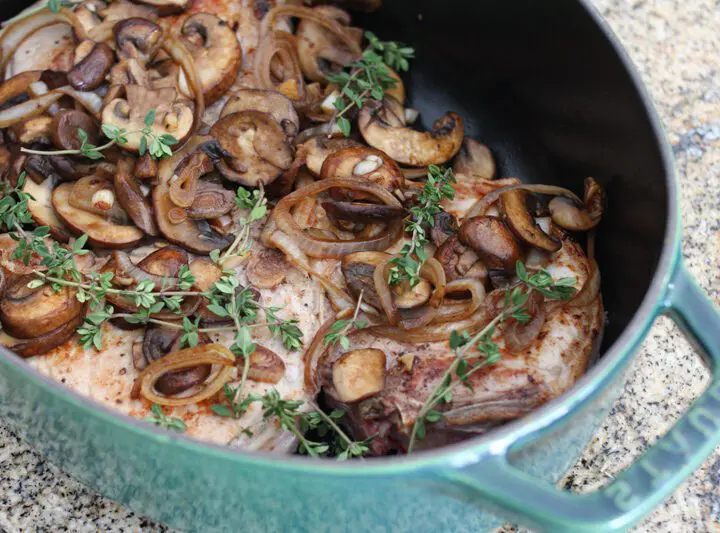 braised pork chops with mushrooms in a dutch oven