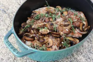 pork chops and mushrooms in a dutch oven