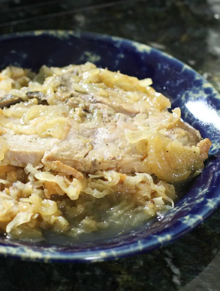 Pork chops with sauerkraut on a plate.