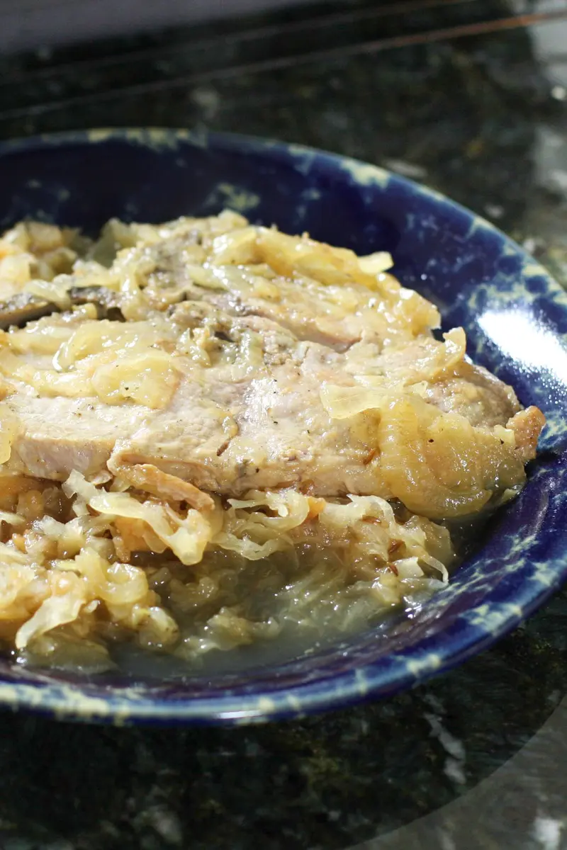 Pork chops with sauerkraut on a plate.