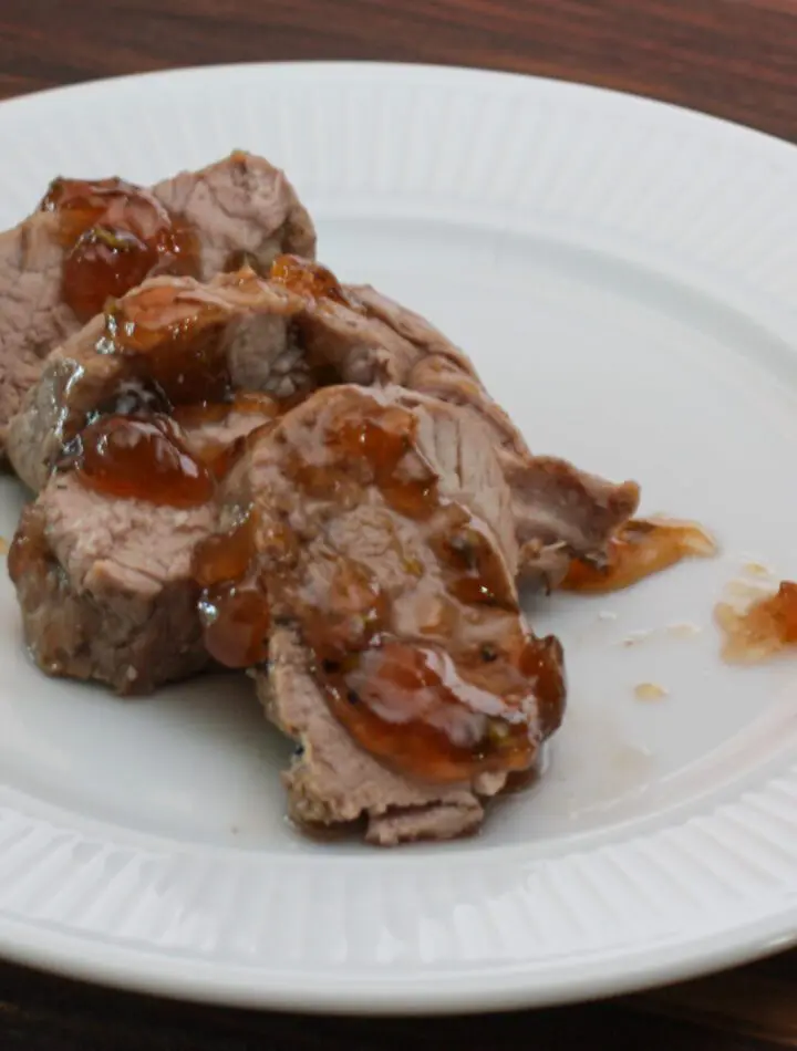 roasted pork tenderloin with jalapeño pepper glaze on a plate, sliced