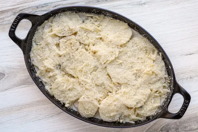 Potato gratin ready to bake with Gruyere cheese and Parmesan topping.