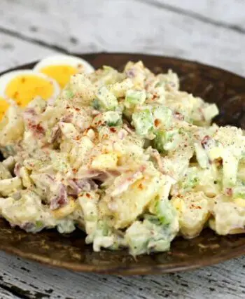 buttermilk potato salad on a plate with extra sliced hard boiled eggs.