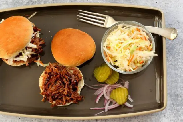 pulled pork sandwiches with coleslaw on the side