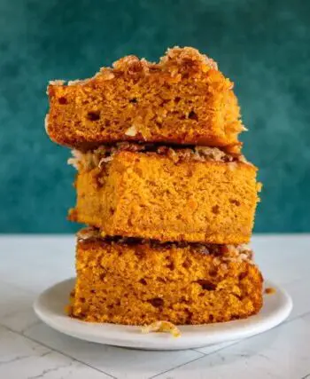 pumpkin cake with broiled coconut pecan topping, stacked on a plate