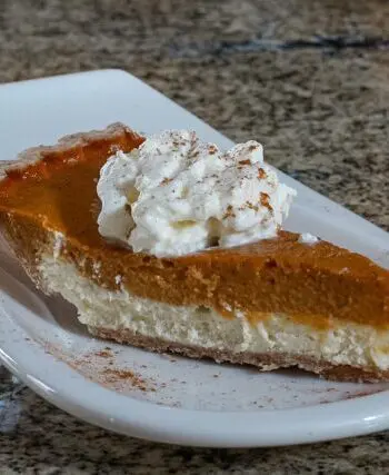 pumpkin pie with cream cheese layer on a dessert plate