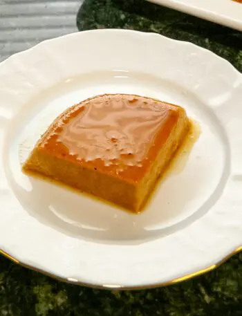 A slice of pumpkin flan on a dessert plate