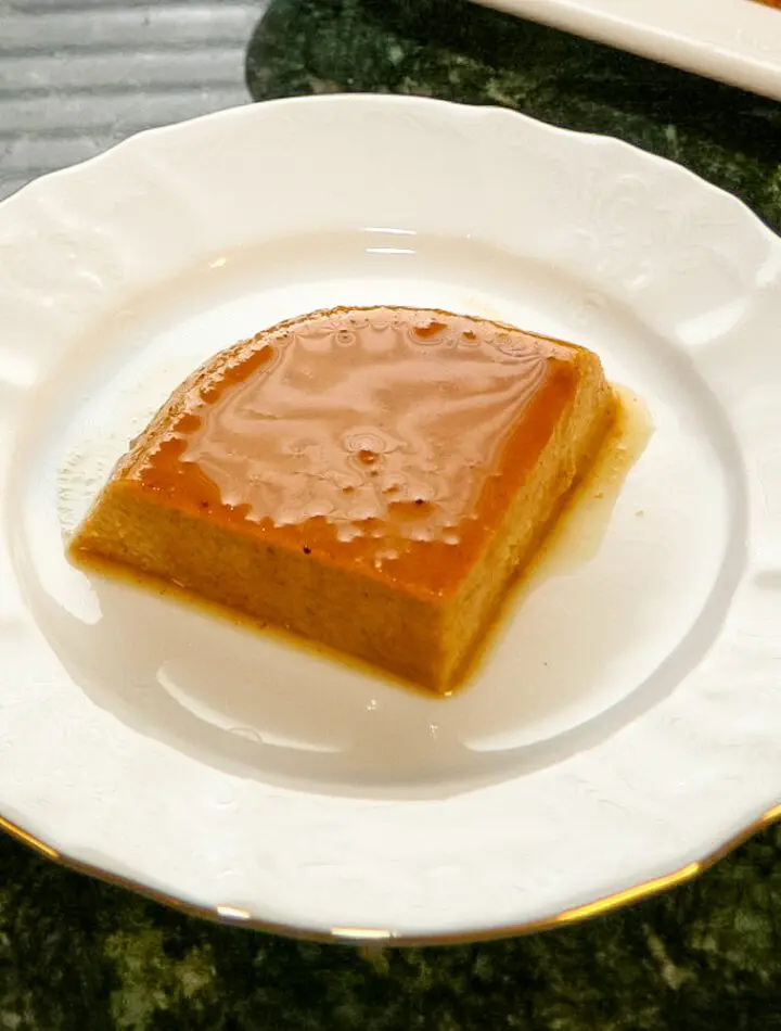 A slice of pumpkin flan on a dessert plate