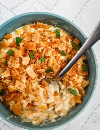 quick skillet scalloped corn in a serving bowl with spoon