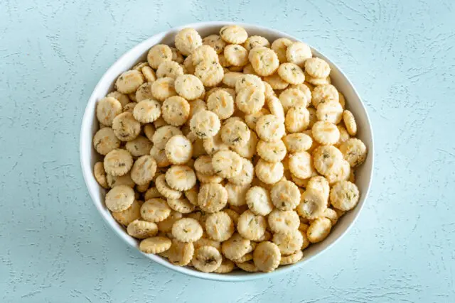 Oyster crackers with ranch dressing and dill in a large serving bowl.