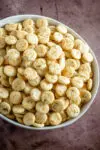 Oyster crackers with ranch dressing and dill in a large serving bowl.