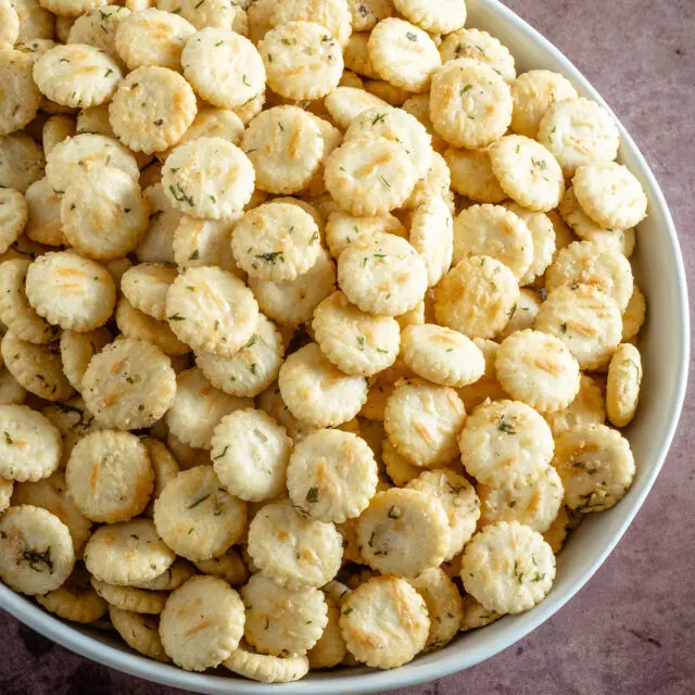 Oyster crackers with ranch dressing and dill in a large serving bowl.