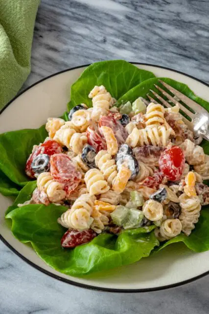 Ranch pasta salad served on a plate with lettuce leaves