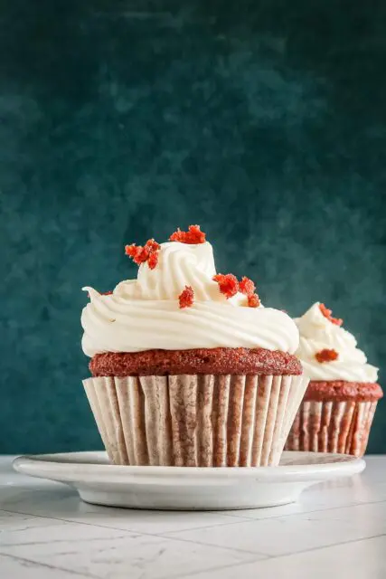 A red velvet cupcake with another one in the background