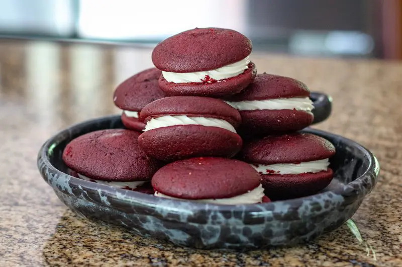 red velvet whoopie pies stacked in a serving dish