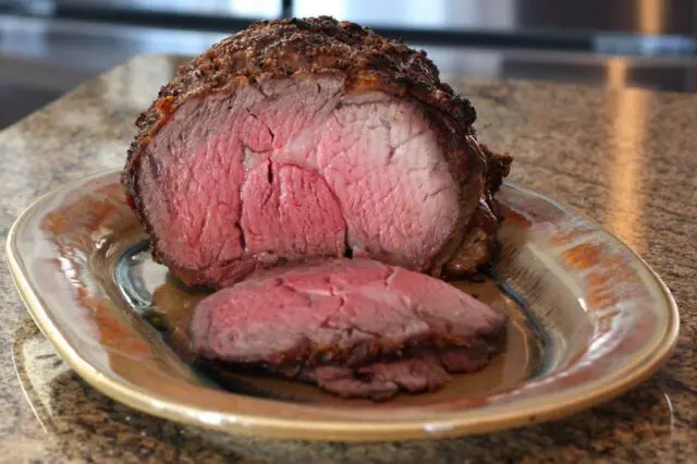 rib eye roast on a platter, sliced