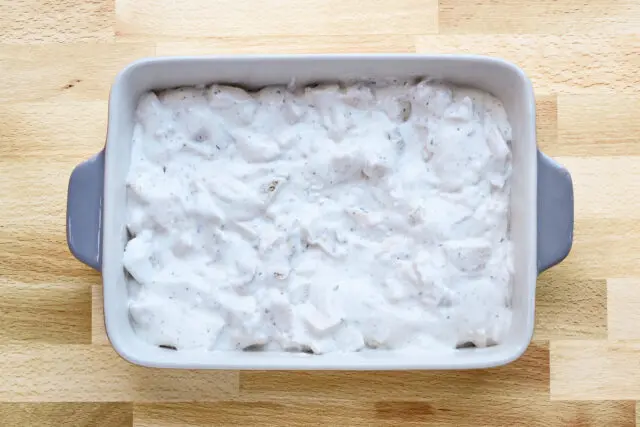 The creamy Ritz chicken casserole filling is in the prepared baking dish.