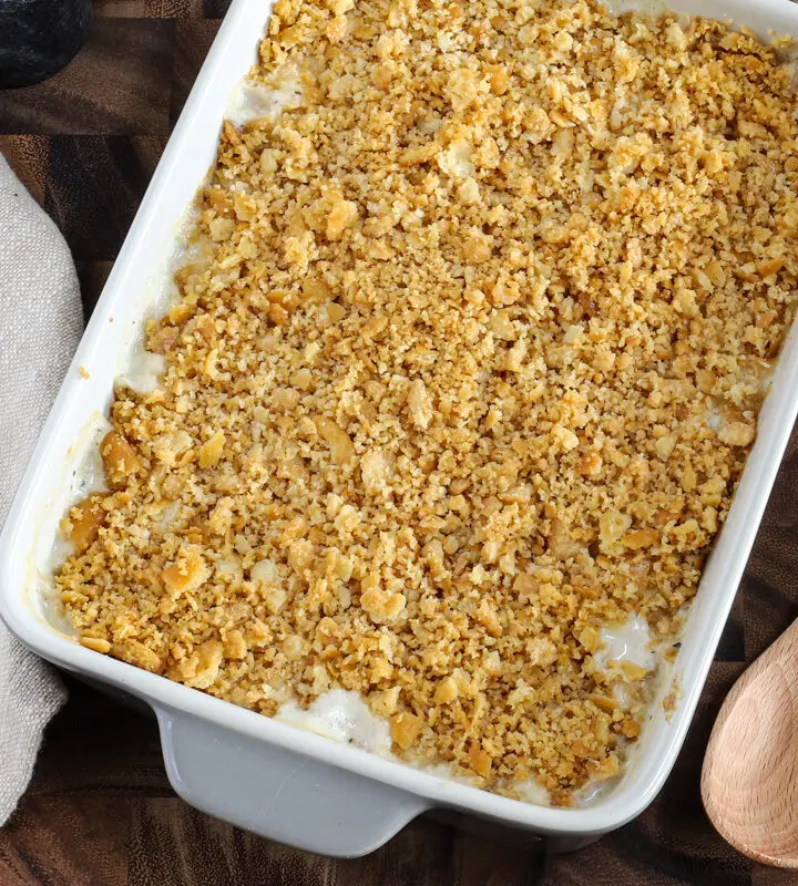 A baked Ritz chicken casserole with serving spoon, ready to enjoy!