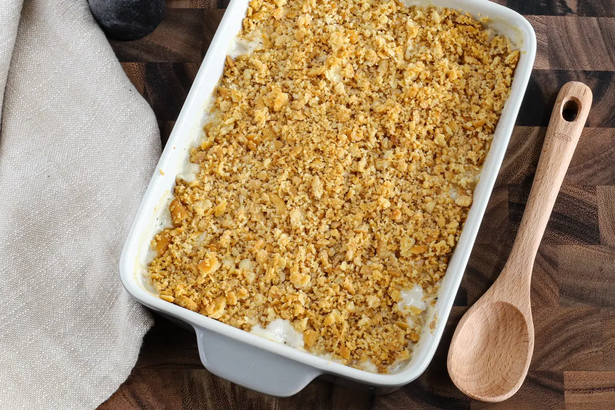 A baked Ritz chicken casserole with serving spoon, ready to enjoy!