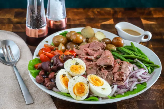 A flavorful composed Nicoise salad made with deli sliced roast beef and traditional Nicoise ingredients, finished with a Dijon dressing.