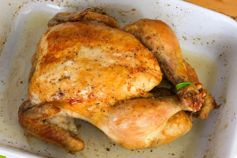 whole roasted chicken in a baking dish