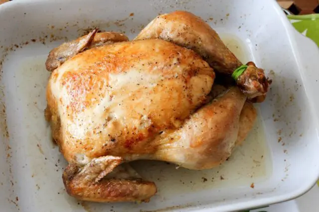 baking dish with a whole roasted chicken