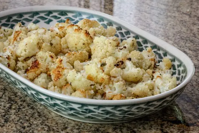 roasted cauliflower with lemon in a serving dish