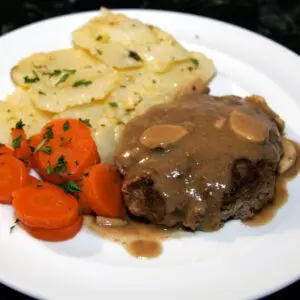 a salisbury steak meal on a dinner plate