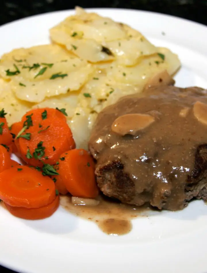 plate of salisbury steak, mushroom gravy, and potatoes