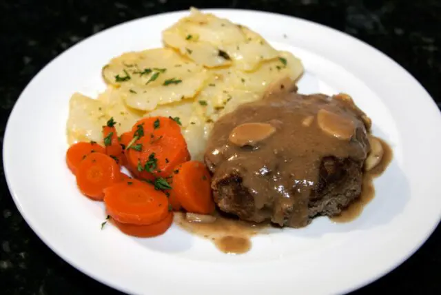 plate of salisbury steak, mushroom gravy, and potatoes