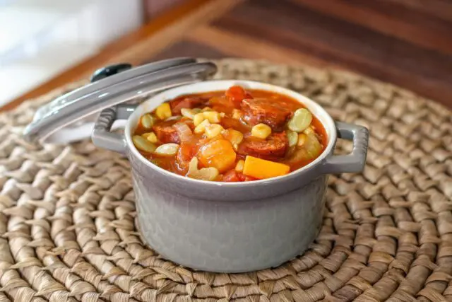 sausage and butternut squash stew with tomatoes and corn in a serving size cocotte