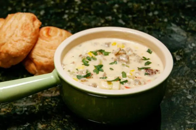 corn chowder with sausage in a soup bowl