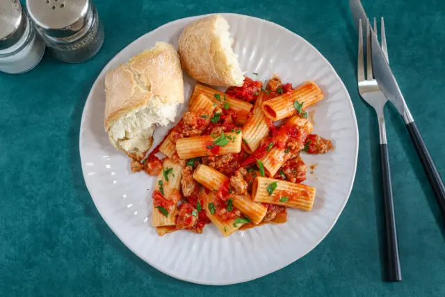 Overhead shot of a sausage ragu tossed with rigatoni.