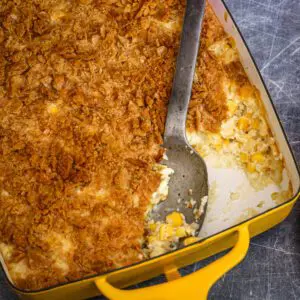 scalloped corn casserole in a baking dish