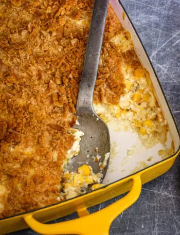 a scalloped corn casserole in a baking dish