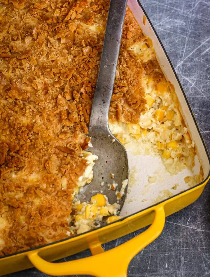 a scalloped corn casserole in a baking dish