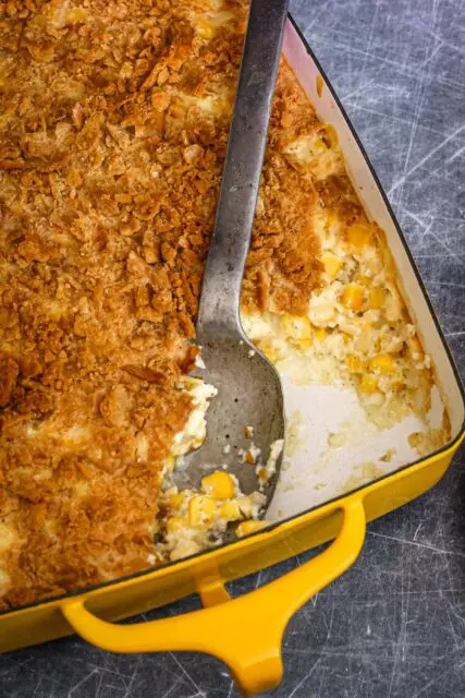 a scalloped corn casserole in a baking dish