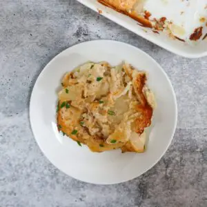 A plate with classic scalloped potatoes garnished with chives