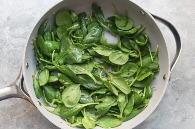 spinach and aromatics in the pan