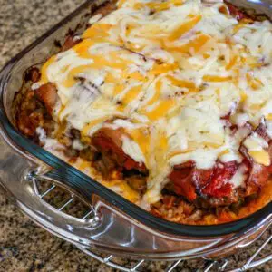 seven layer ground beef casserole topped with melted cheese