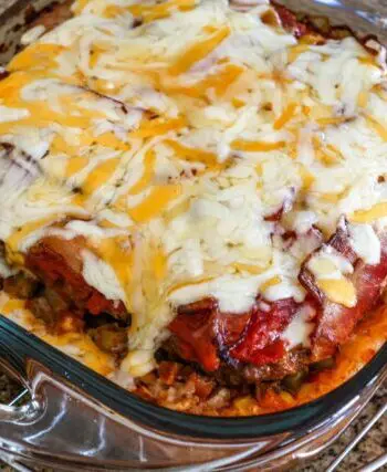 seven layer ground beef casserole with melted cheese on top