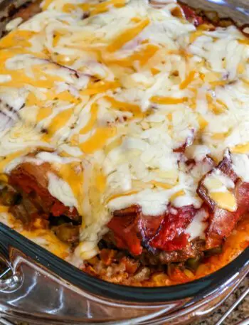 seven layer ground beef casserole with melted cheese on top