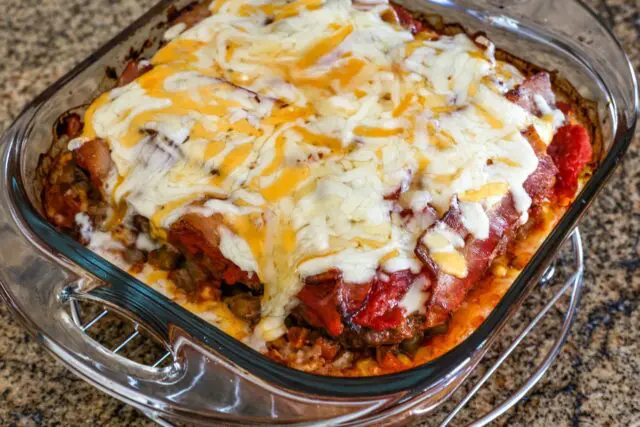 seven layer ground beef casserole with melted cheese on top