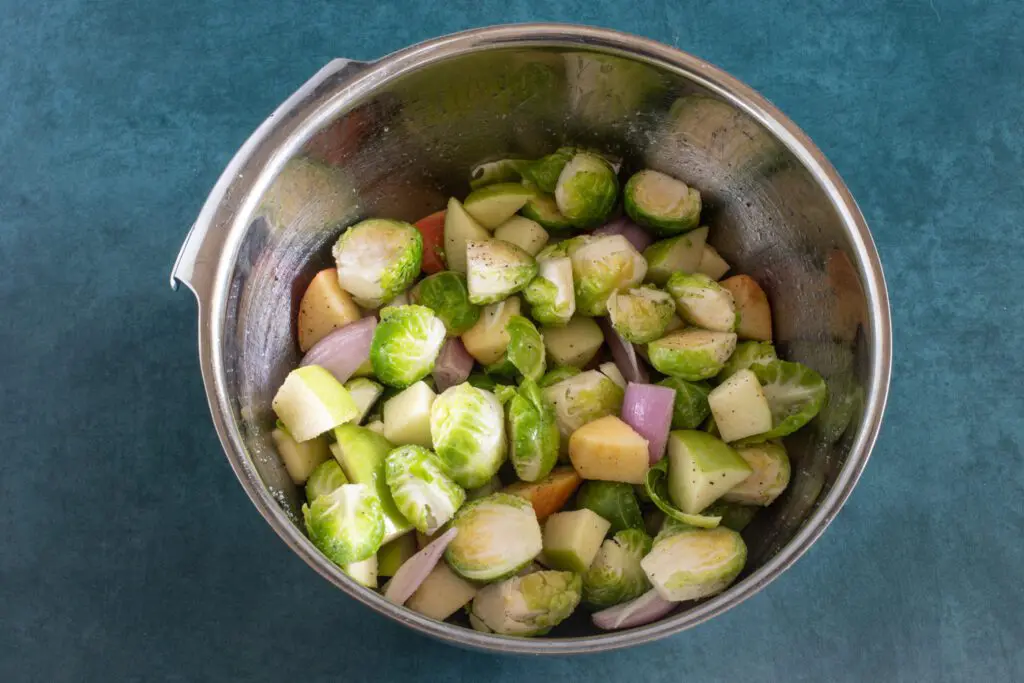 brussels sprouts, apples, and shallots in a bowl