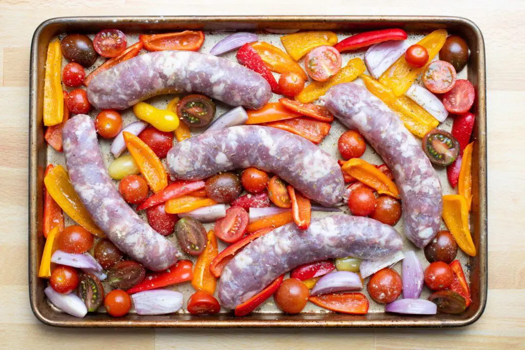 preparation, sausages and peppers in the sheet pan