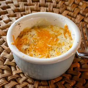 shirred eggs with cheese in a ramekin