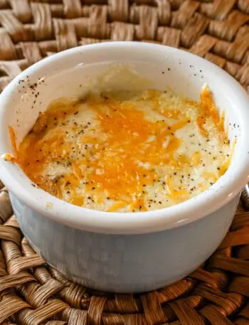 shirred eggs with cheese in a ramekin