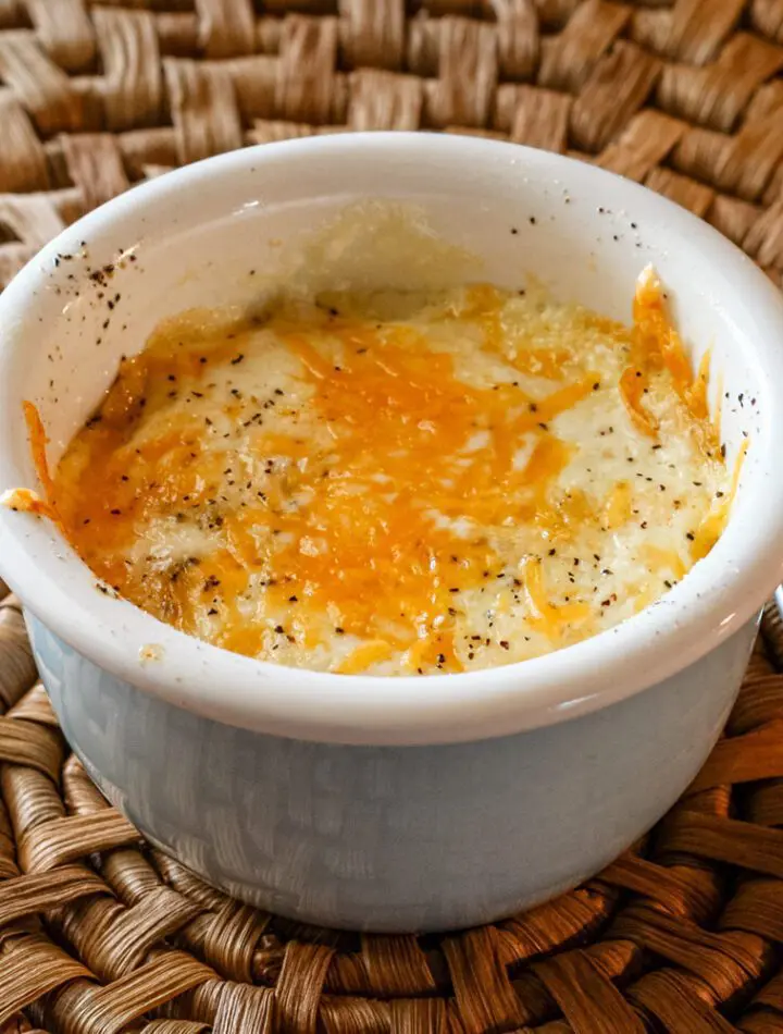 shirred eggs with cheese in a ramekin