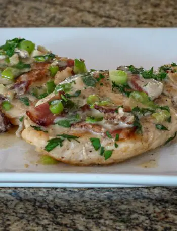 chicken with bacon and sour cream sauce on a serving plate